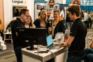 Attendees Engaged with a Vendor at an Expo